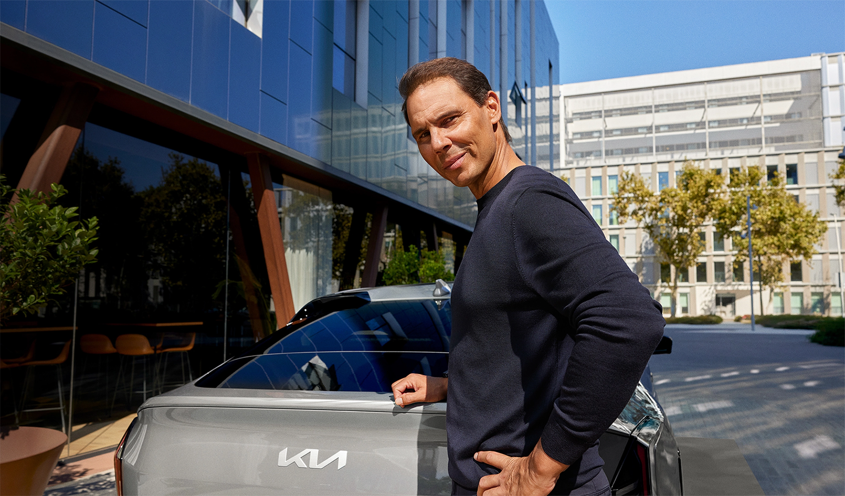 Rafael Nadal standing next to the EV4.