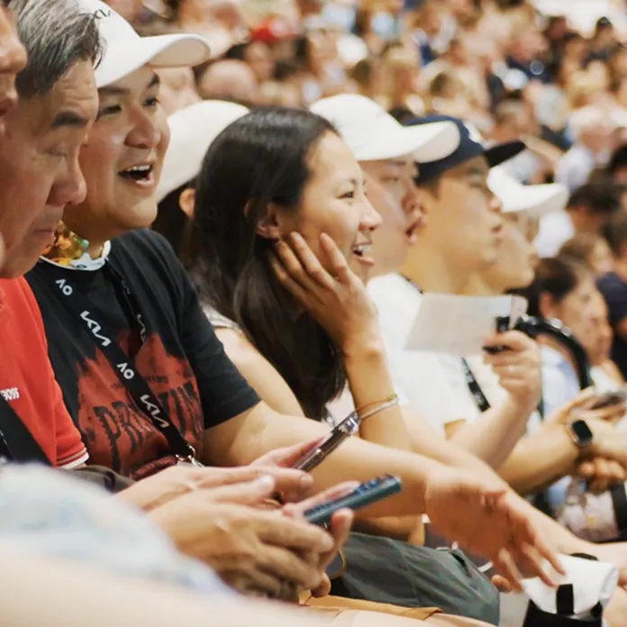 Spectators cheering during a tennis match