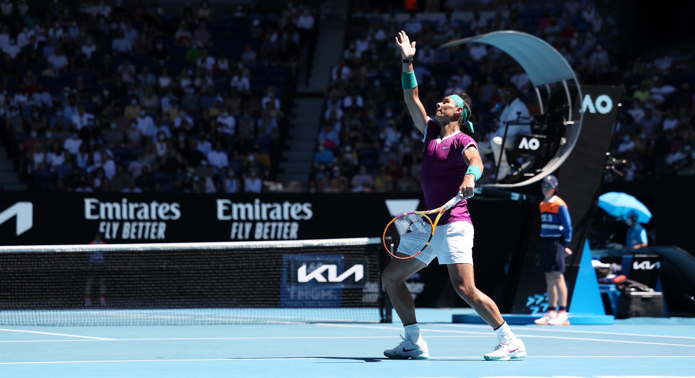 A tennis player jumping to hit a shot during a match.