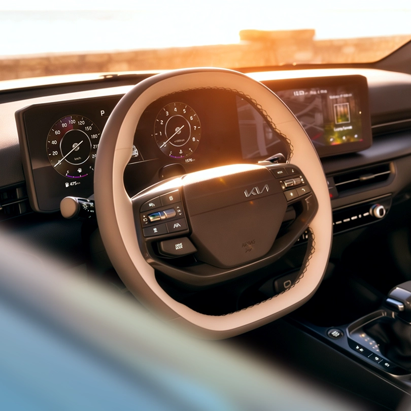 Kia vehicle interior featuring the steering wheel and dashboard