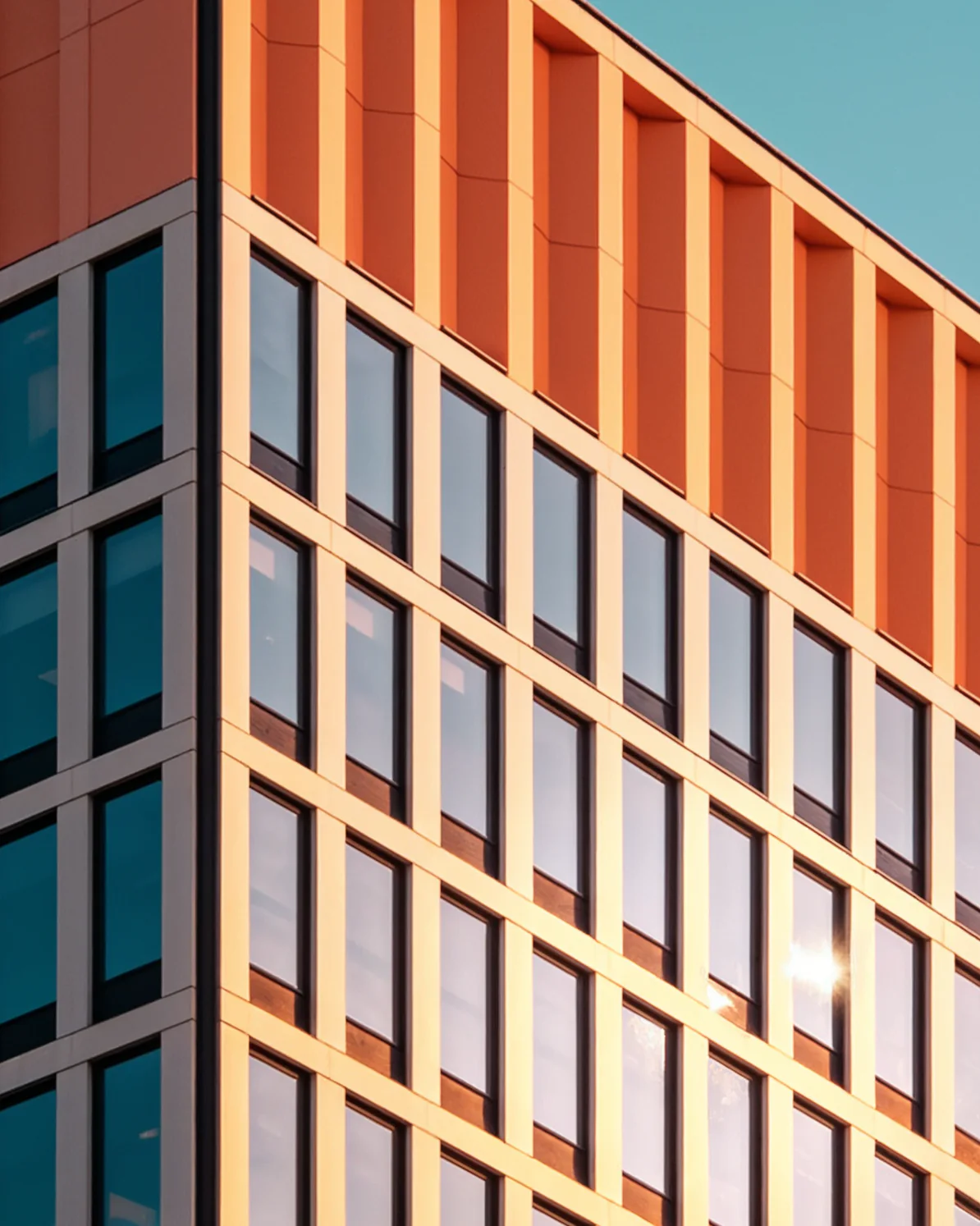 Architectural facade contrasting orange walls and blue glass