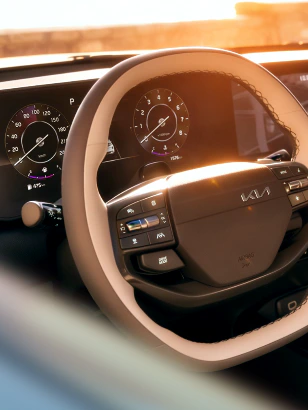 Kia vehicle interior featuring the steering wheel and dashboard