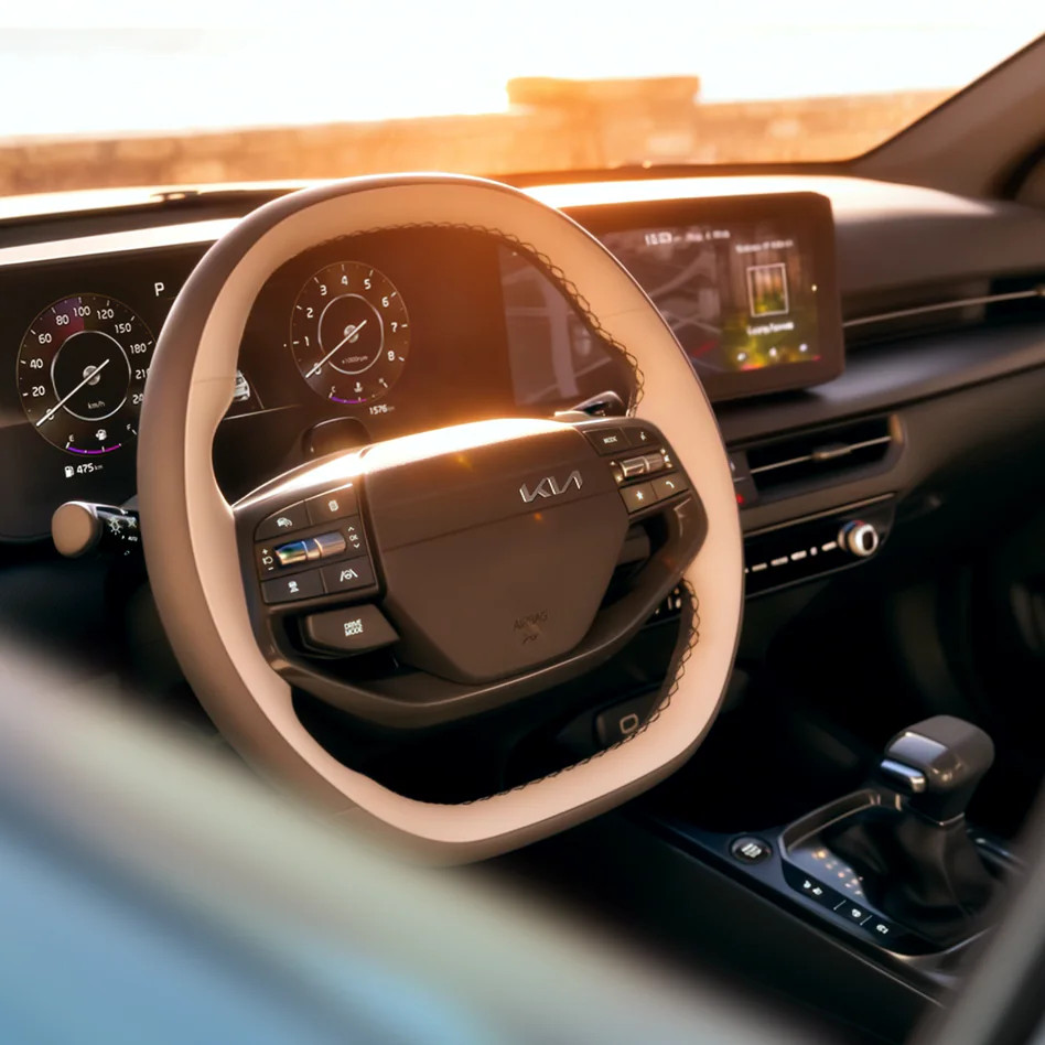 Kia vehicle interior featuring the steering wheel and dashboard