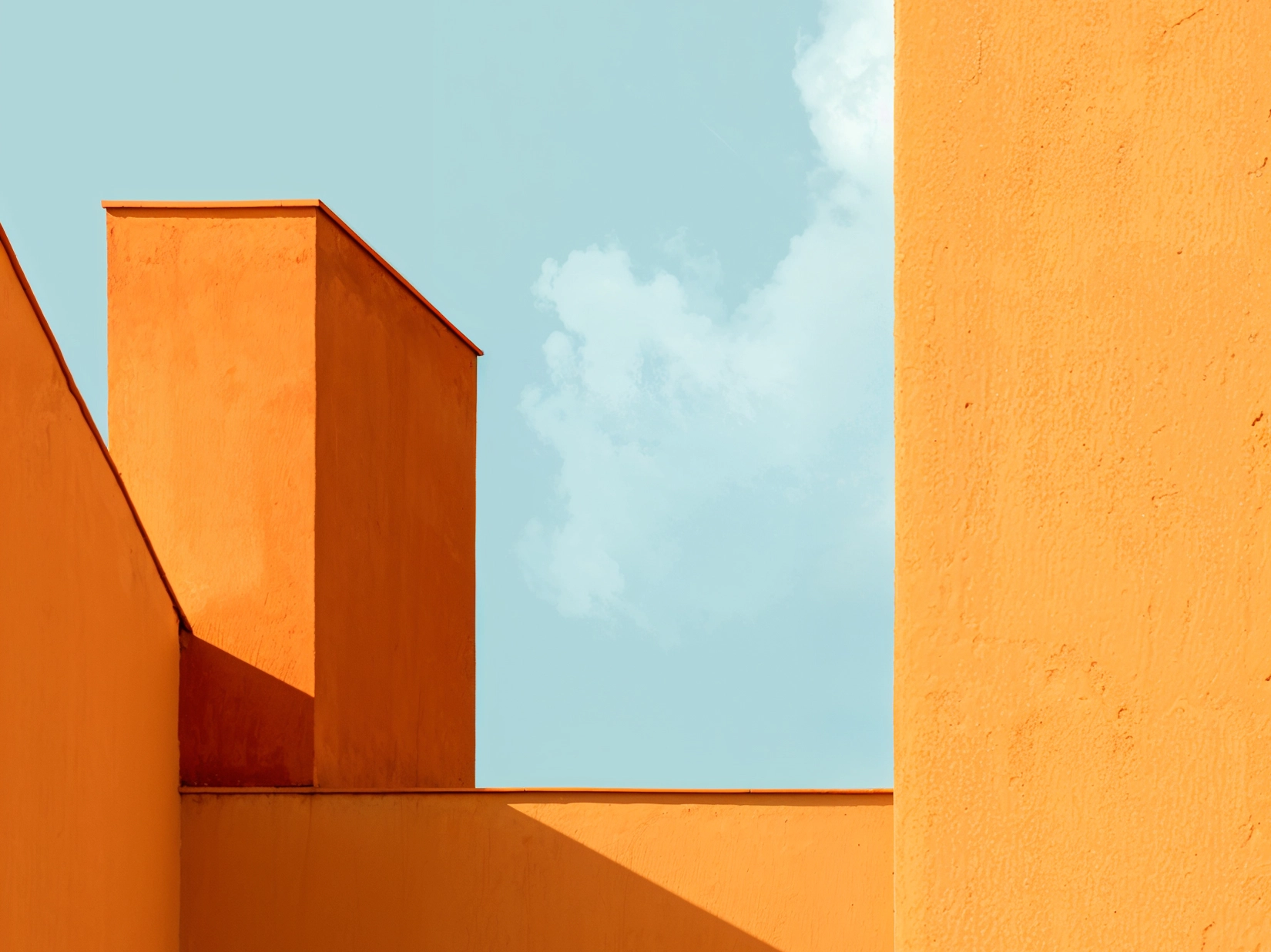 Image of orange architectural structures beneath a blue sky