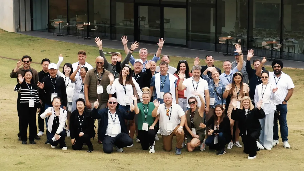 Group photo of Kia officials and participants at the AO event