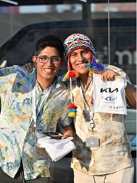 Visitors holding Kia merchandise bags