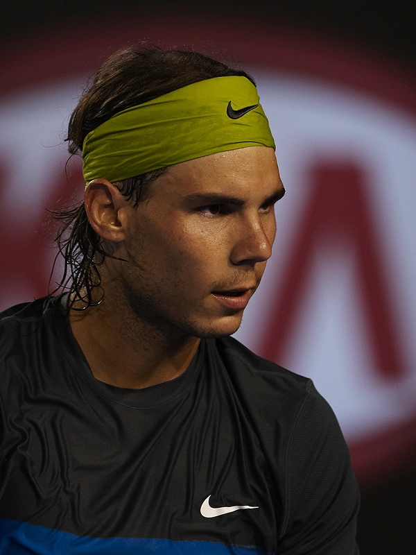 Rafael Nadal competing in front of a Kia-branded backdrop
