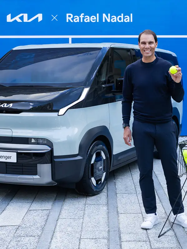 Rafael Nadal posing in front of a Kia PBV vehicle during his visit to Korea