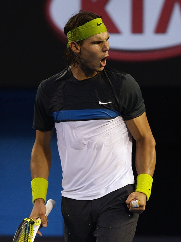 Wide view of a tennis match in a large stadium
