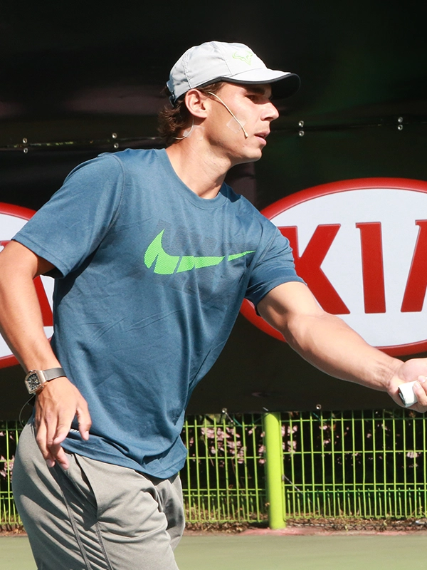 Rafael Nadal shaking hands with an official at a Kia event