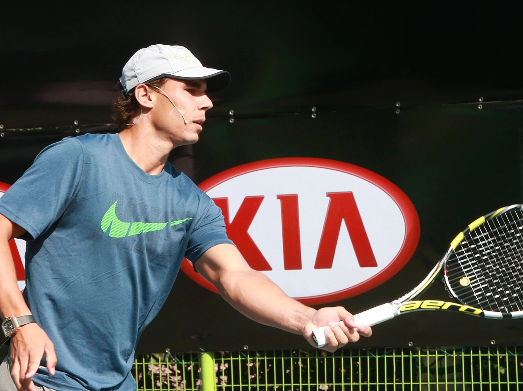 Rafael Nadal shaking hands with an official at a Kia event