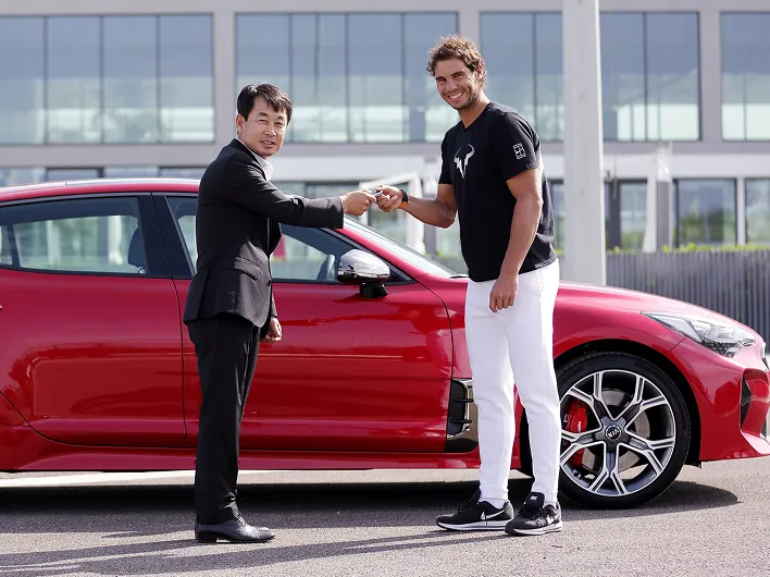 Rafael Nadal posing during a Kia vehicle handover event
