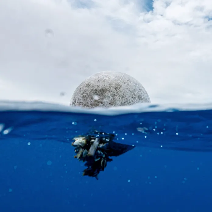 A mass of marine debris floating beneath the ocean surface