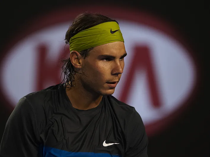 Rafael Nadal competing in front of a Kia-branded backdrop