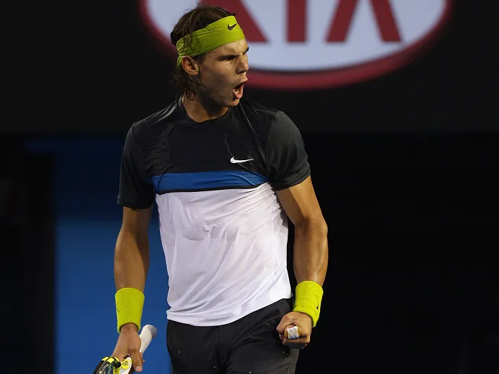Wide view of a tennis match in a large stadium