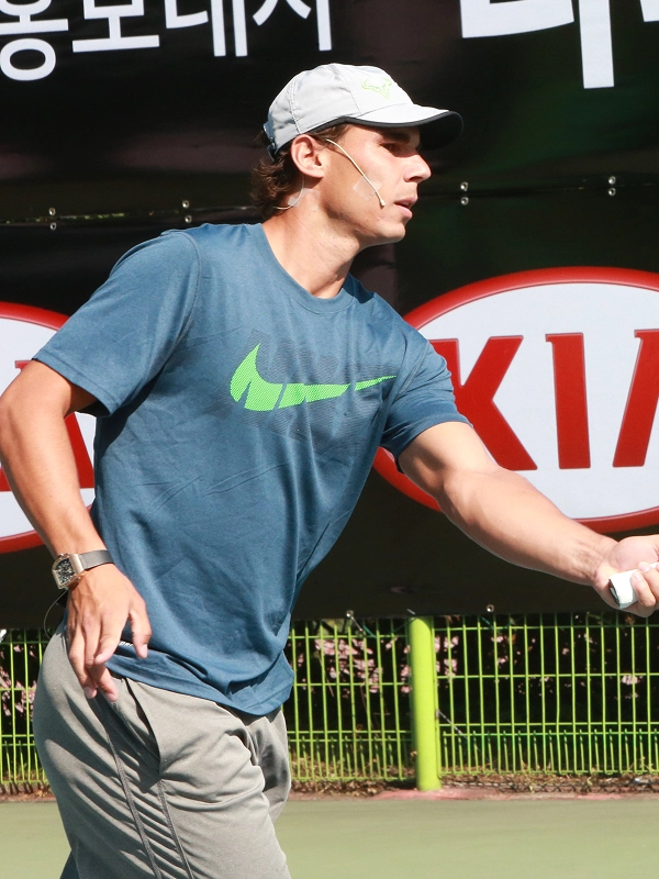 Rafael Nadal shaking hands with an official at a Kia event