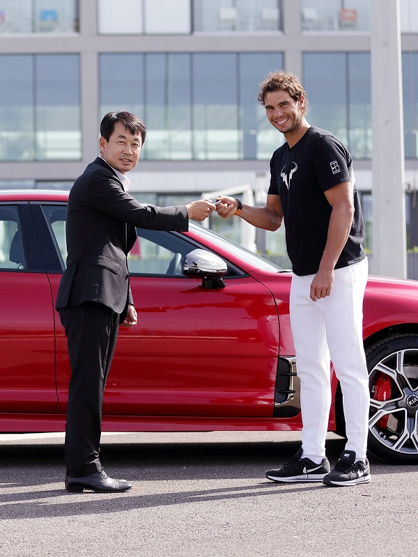 Rafael Nadal posing during a Kia vehicle handover event