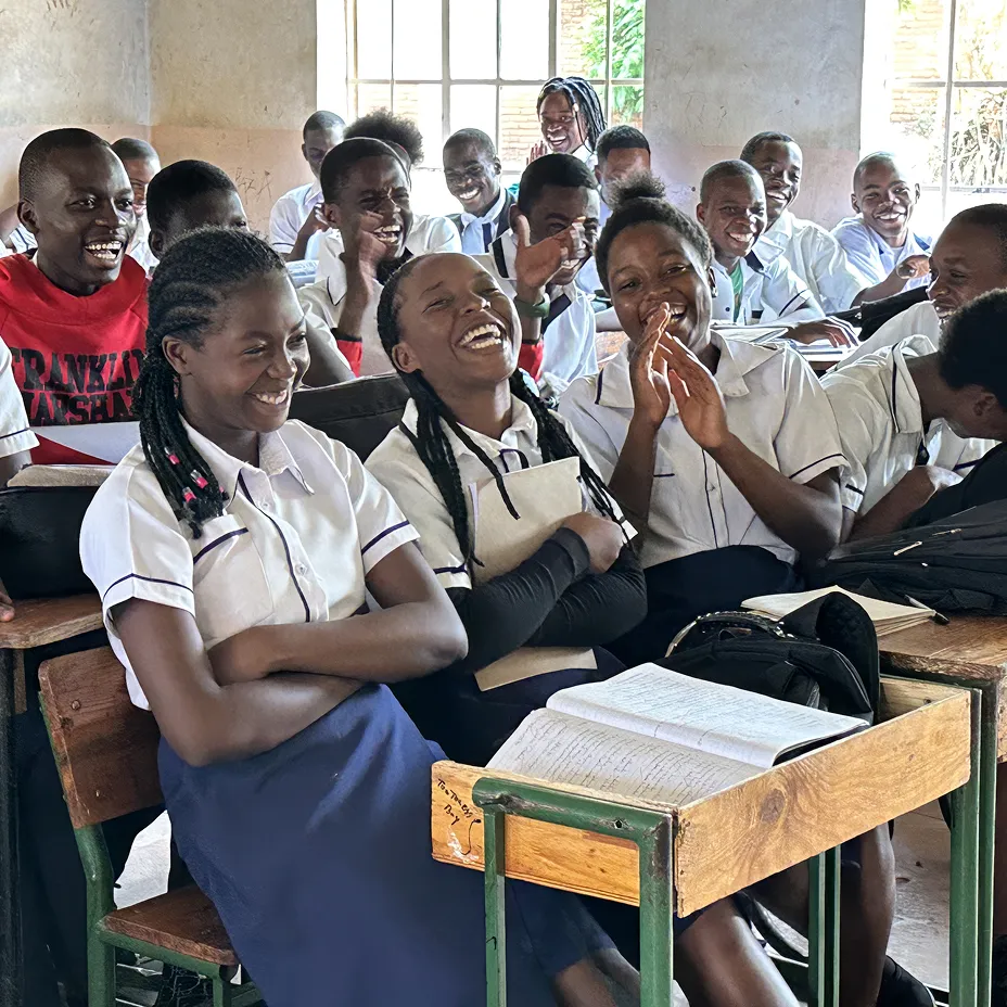 Students in Malawi laughing and participating in a class
