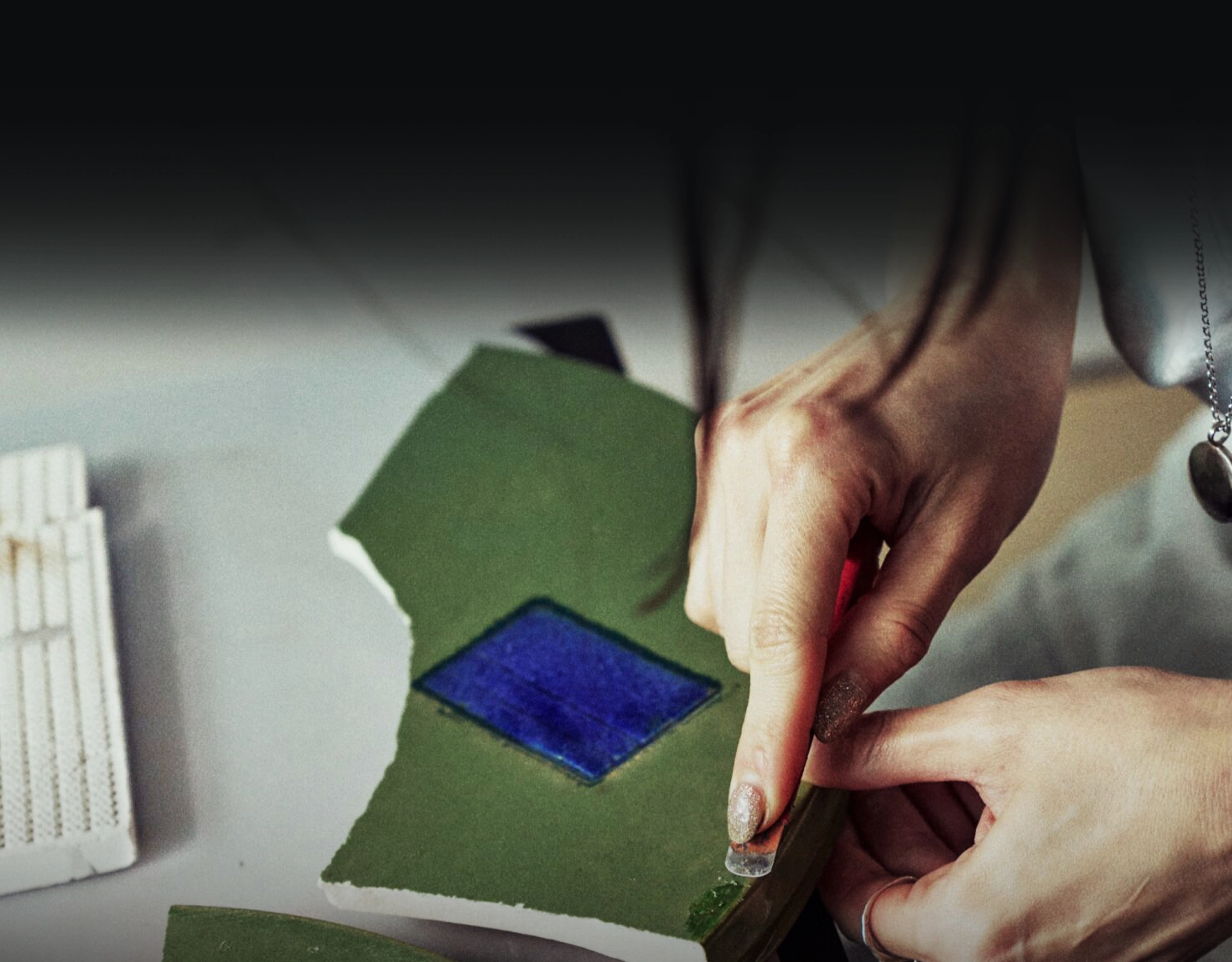 Image of hands processing materials with a crafting tool