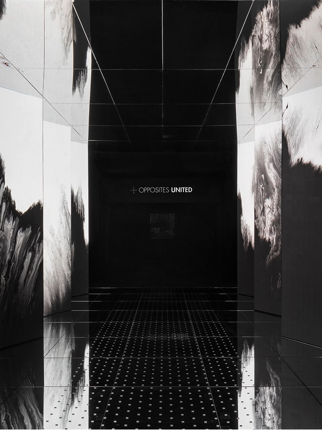Entrance media wall in black and white with a mirrored floor of 'Passage of Footsteps'.