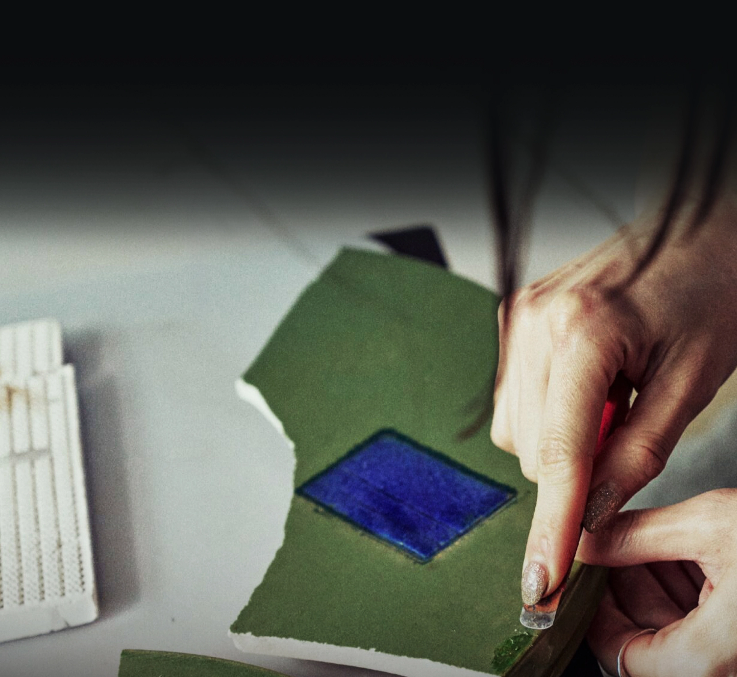 Image of hands processing materials with a crafting tool