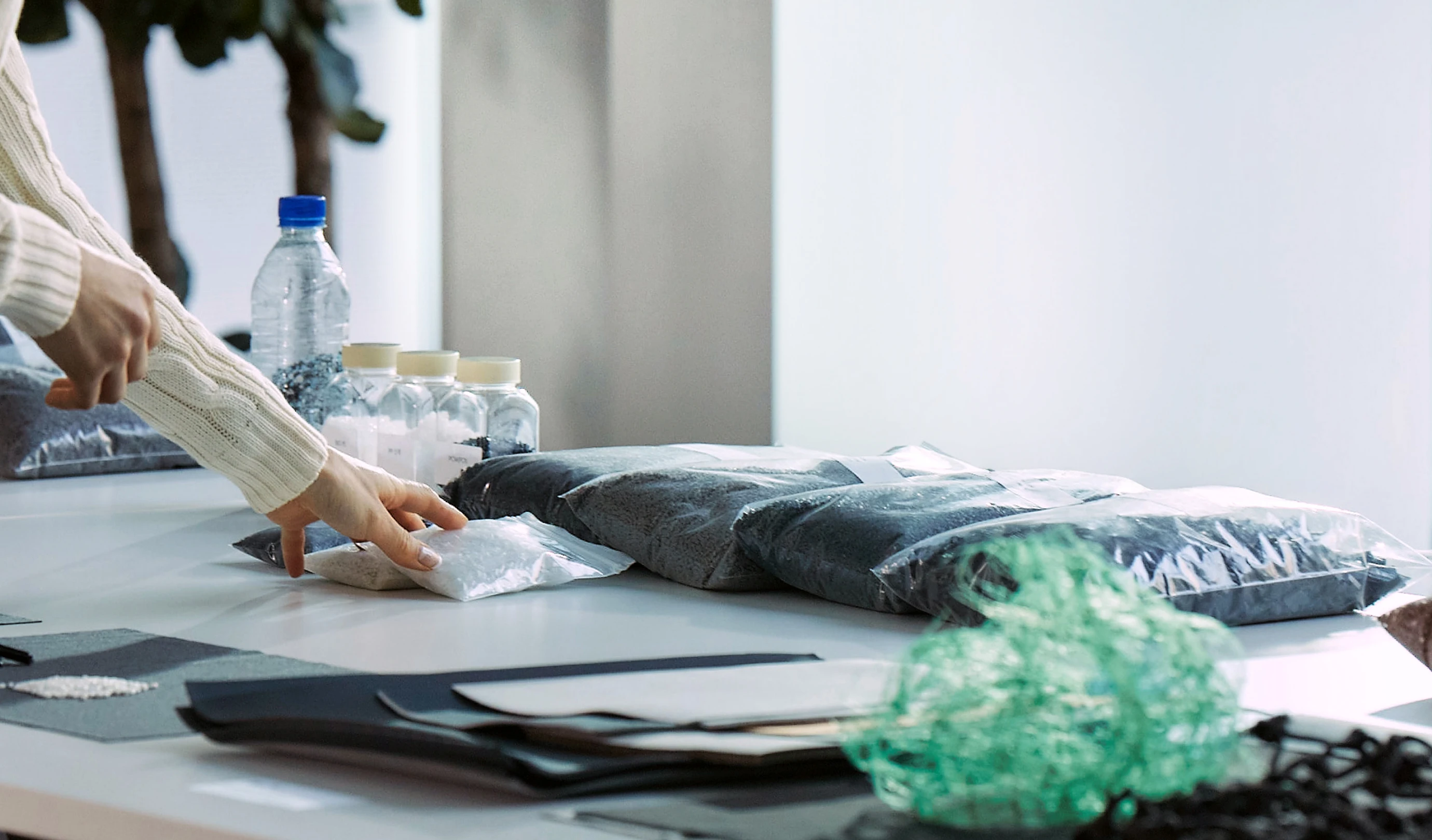 Workspace reviewing plant-based and recycled material samples