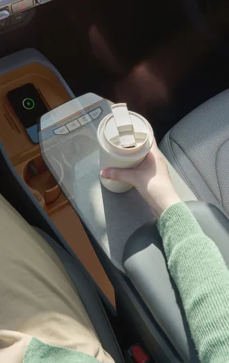 Detail image of a hand holding a cup inside a Kia EV