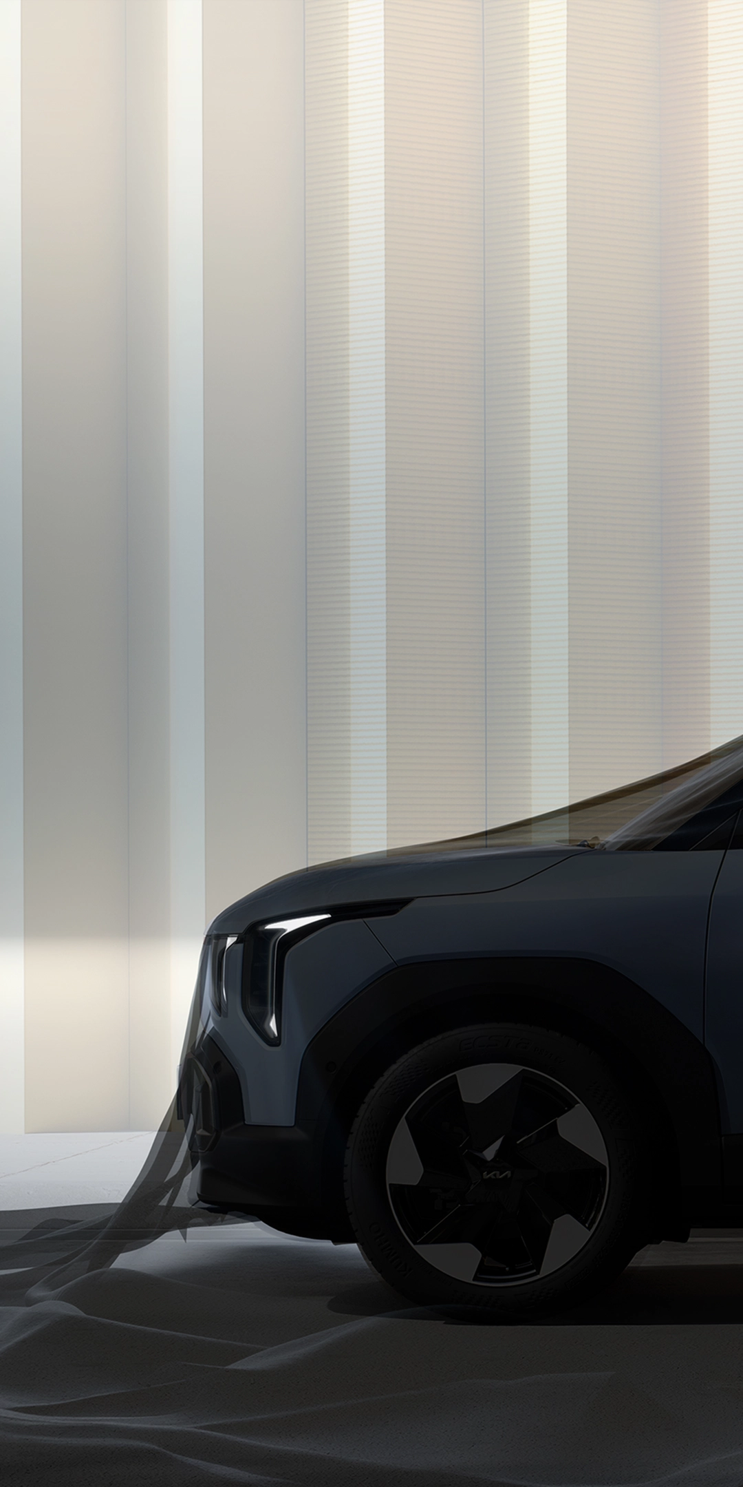 Side view image of Kia EV2 parked in front of urban architecture