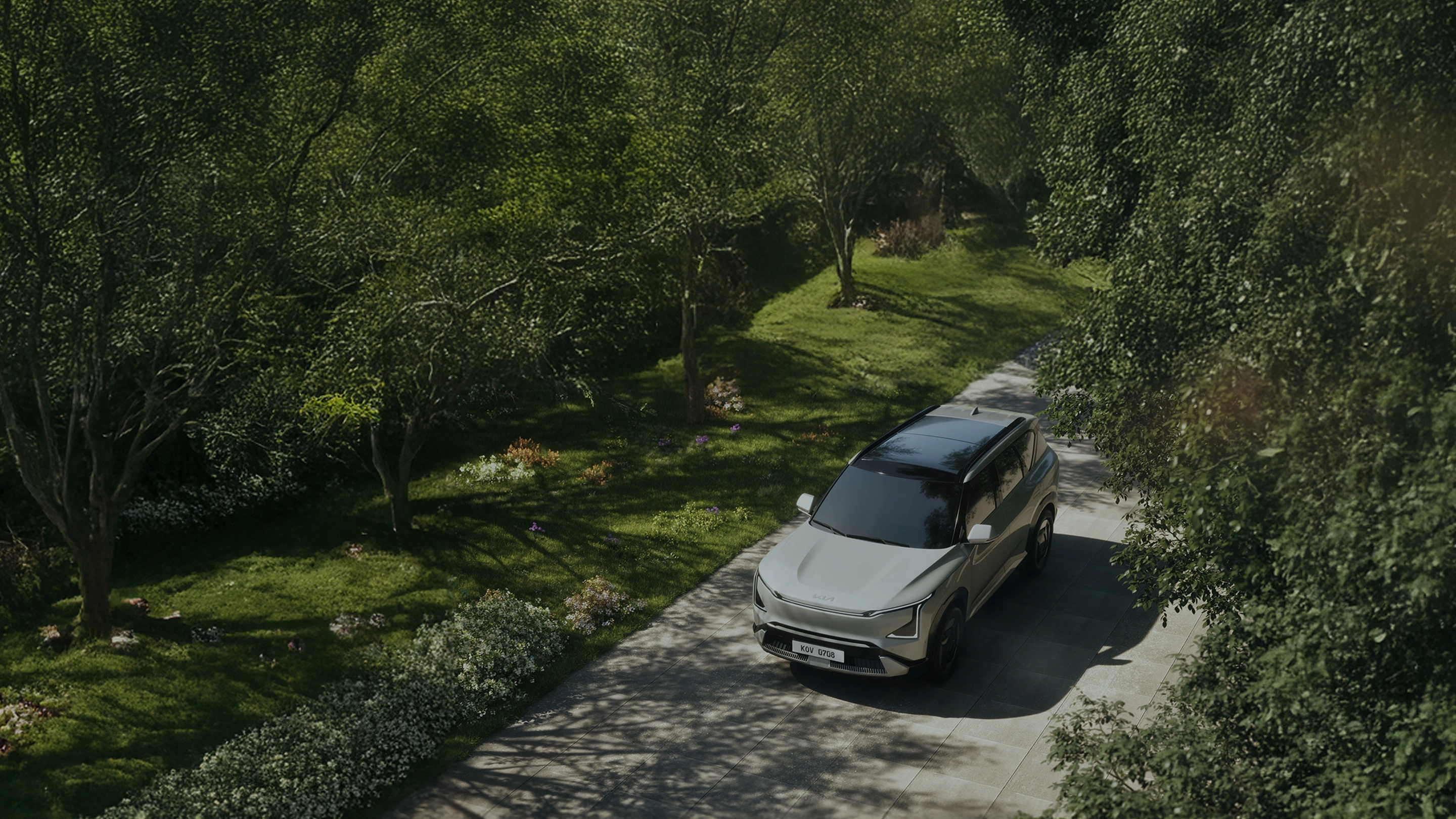 The EV5 driving on a road in nature.