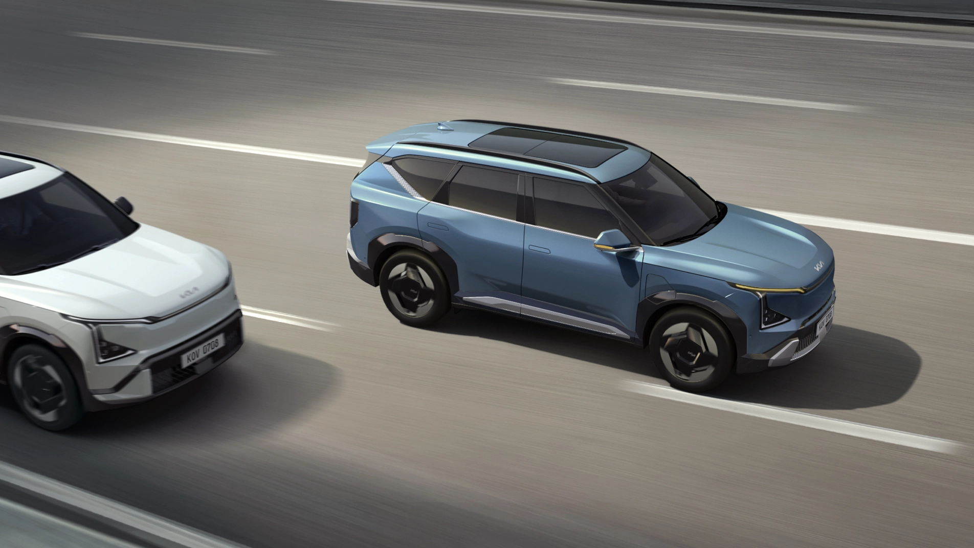 Two EV5 vehicles driving on a road.