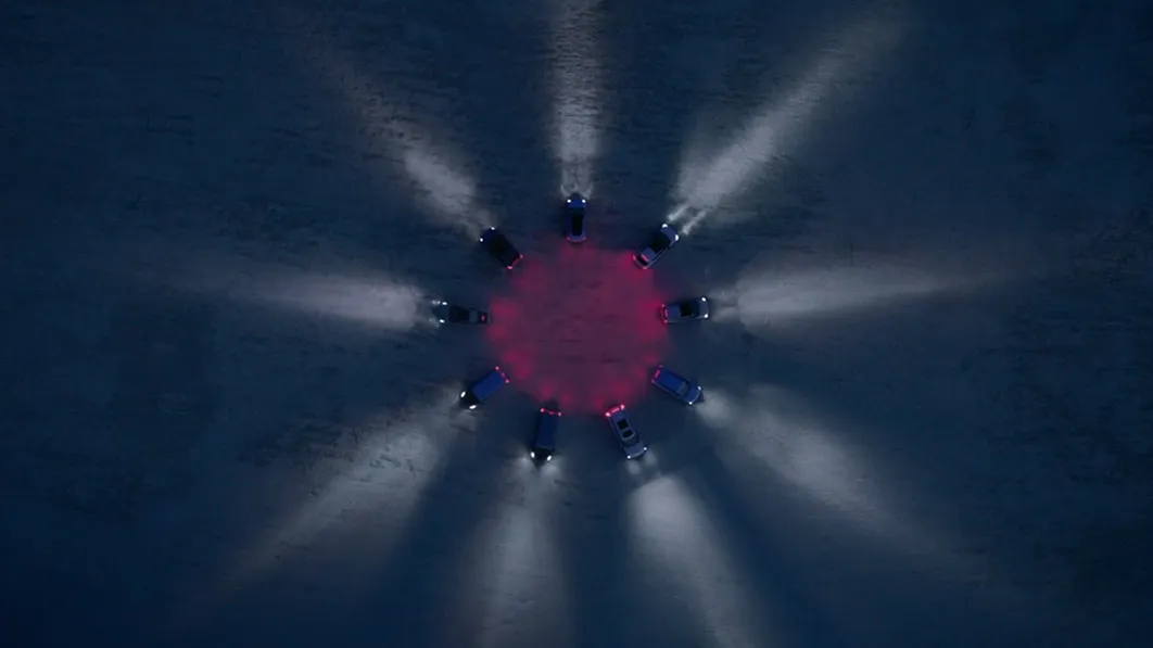 Top view image of Kia vehicles arranged in a circular formation with lighting effects at the 2025 Kia EV Day event