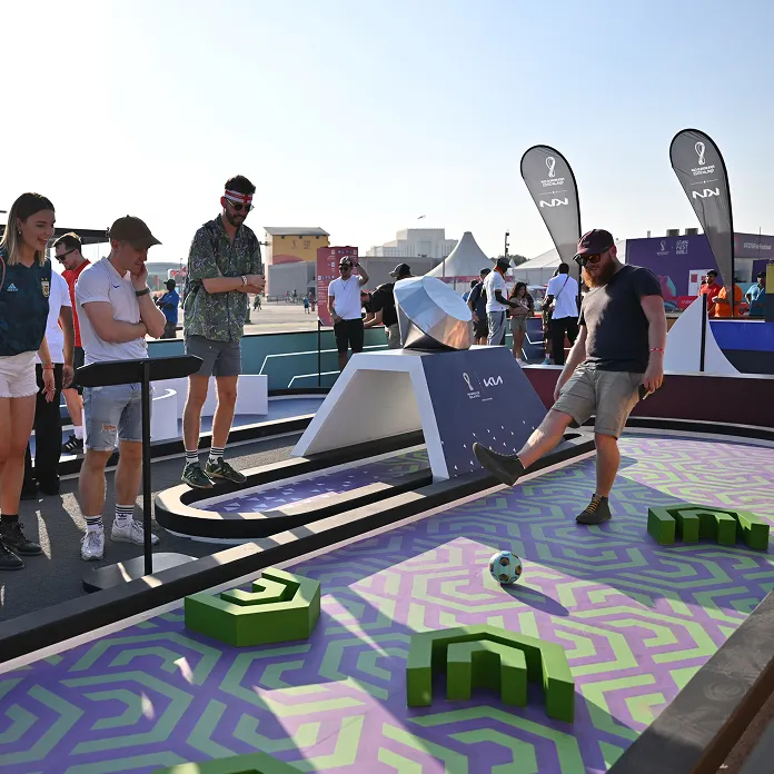 Visitor participating in a football game at a Kia experience zone