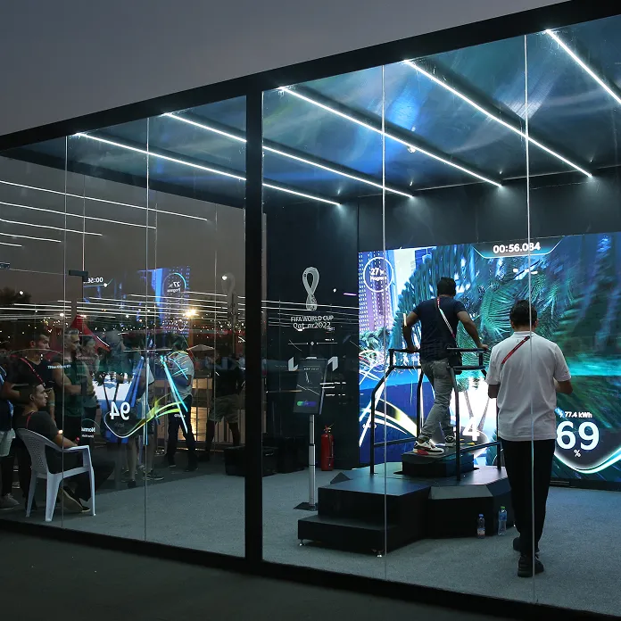 Kia brand experience booth with a large digital screen