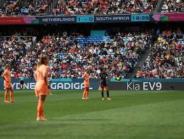 Football stadium scene featuring Kia EV9 advertising