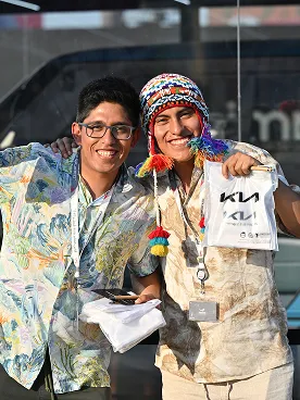 Visitors holding Kia merchandise bags