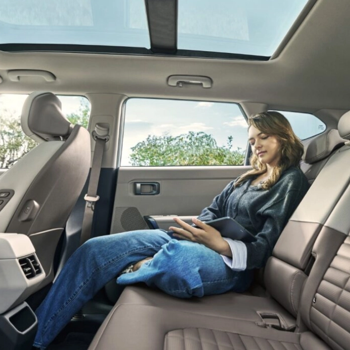 Image of a passenger sitting in the rear seat of a vehicle