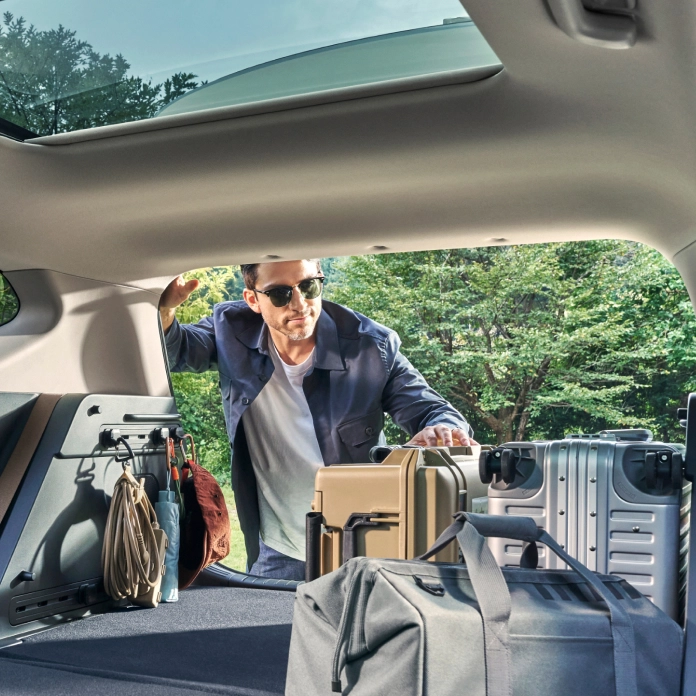 Image of loading luggage into a vehicle trunk