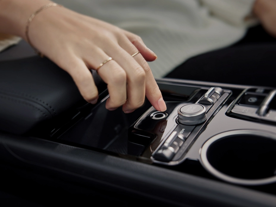 Image of operating the center console inside a Kia vehicle