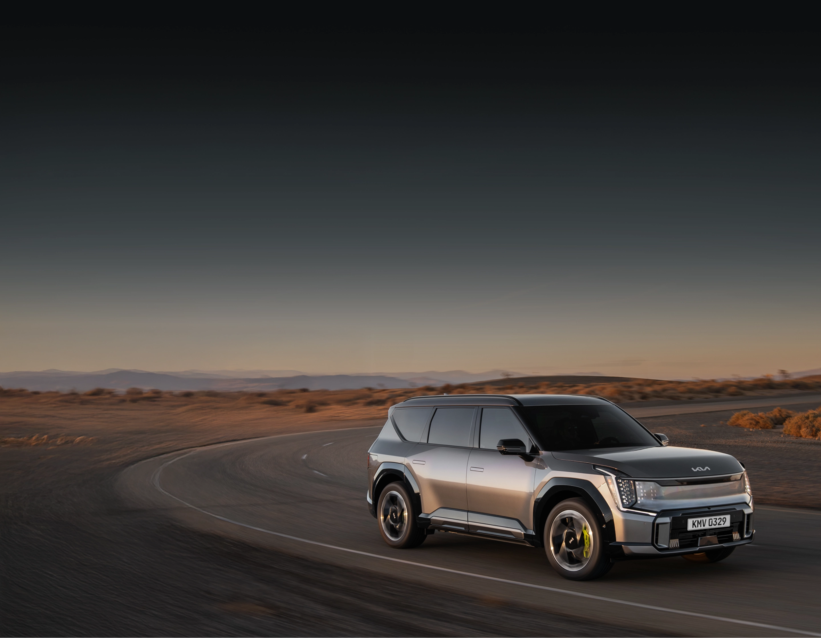 The Kia EV9 driving on a desert road