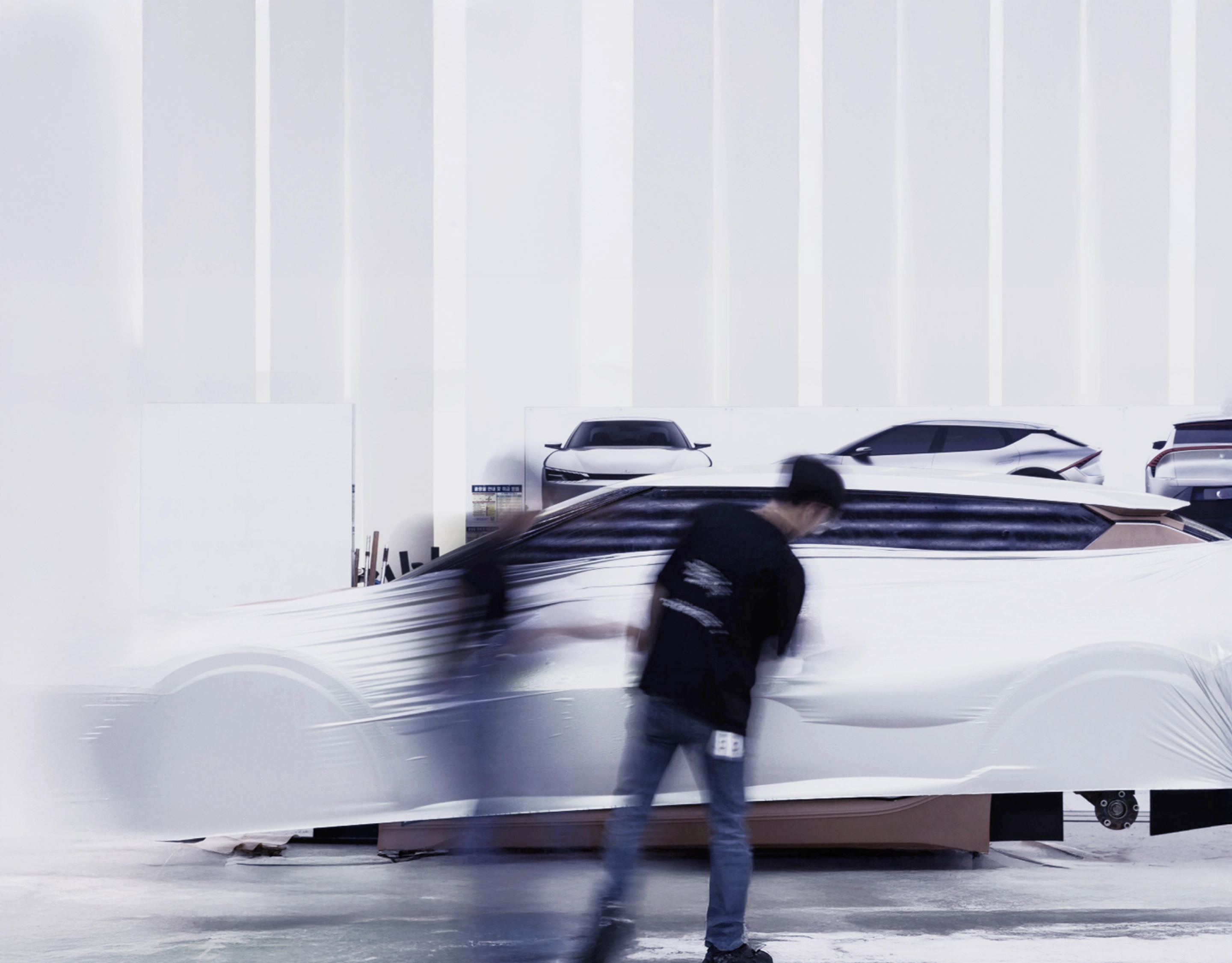 Designer working in front of a clay vehicle model
