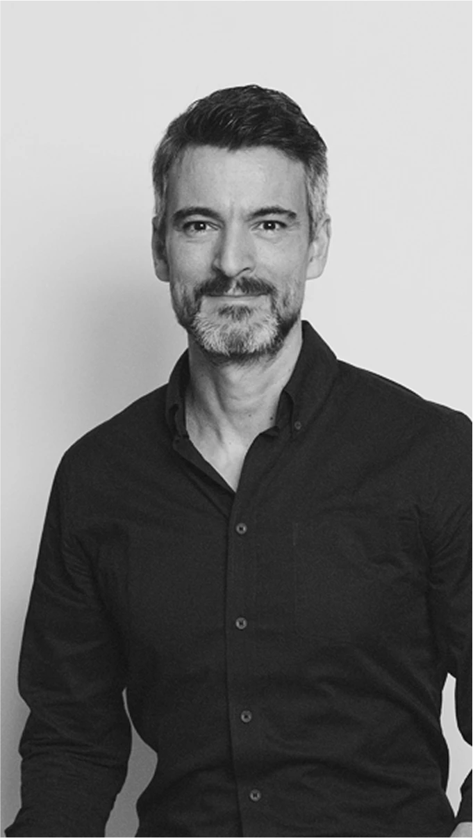 Black-and-white profile portrait of Oliver Sampson, Head of Kia Europe Design Center