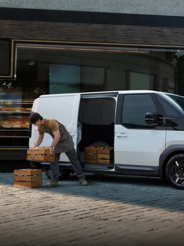 Image of loading cargo from the rear of the Kia PV5 vehicle