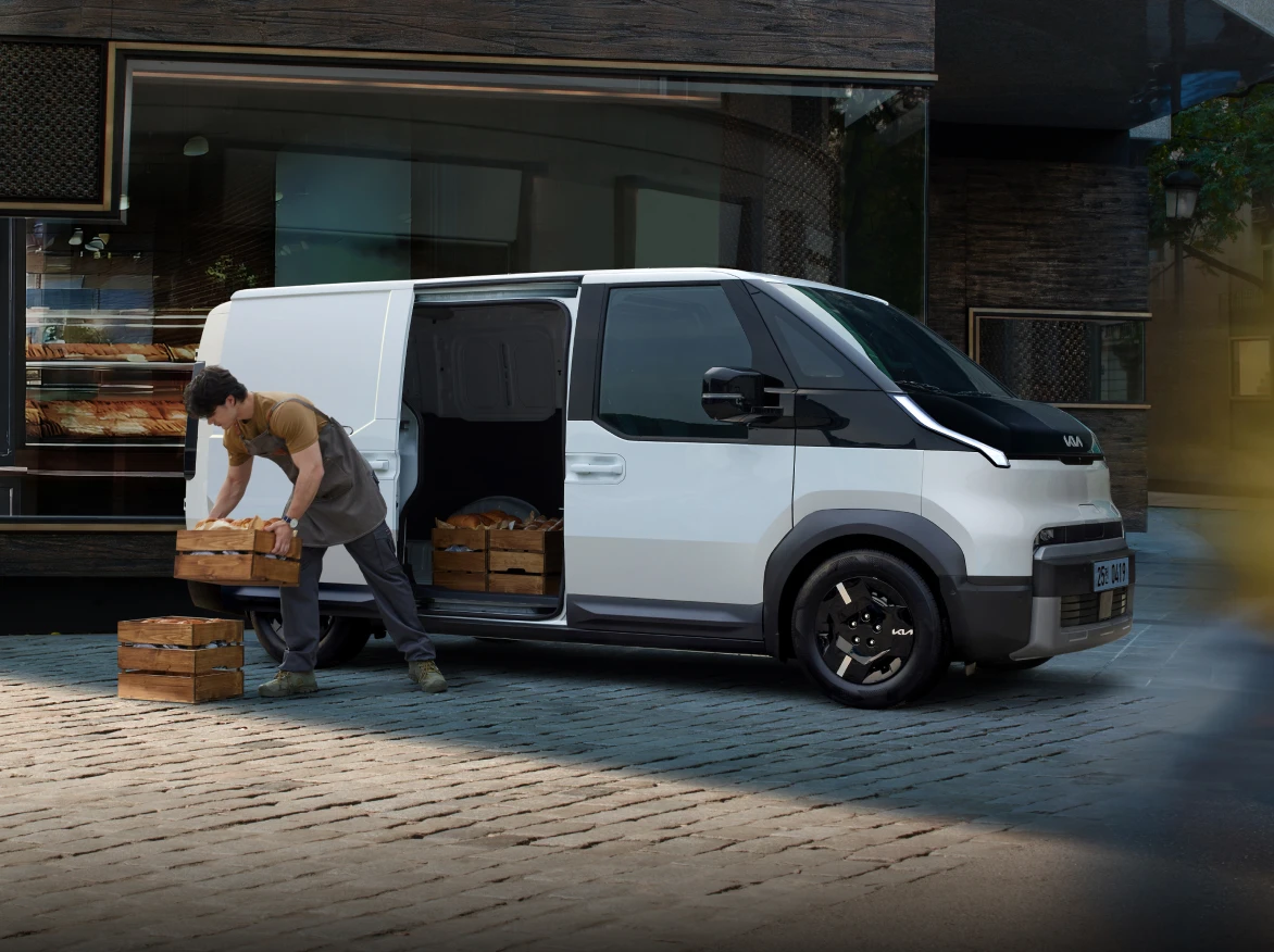 Image of loading cargo from the rear of the Kia PV5 vehicle
