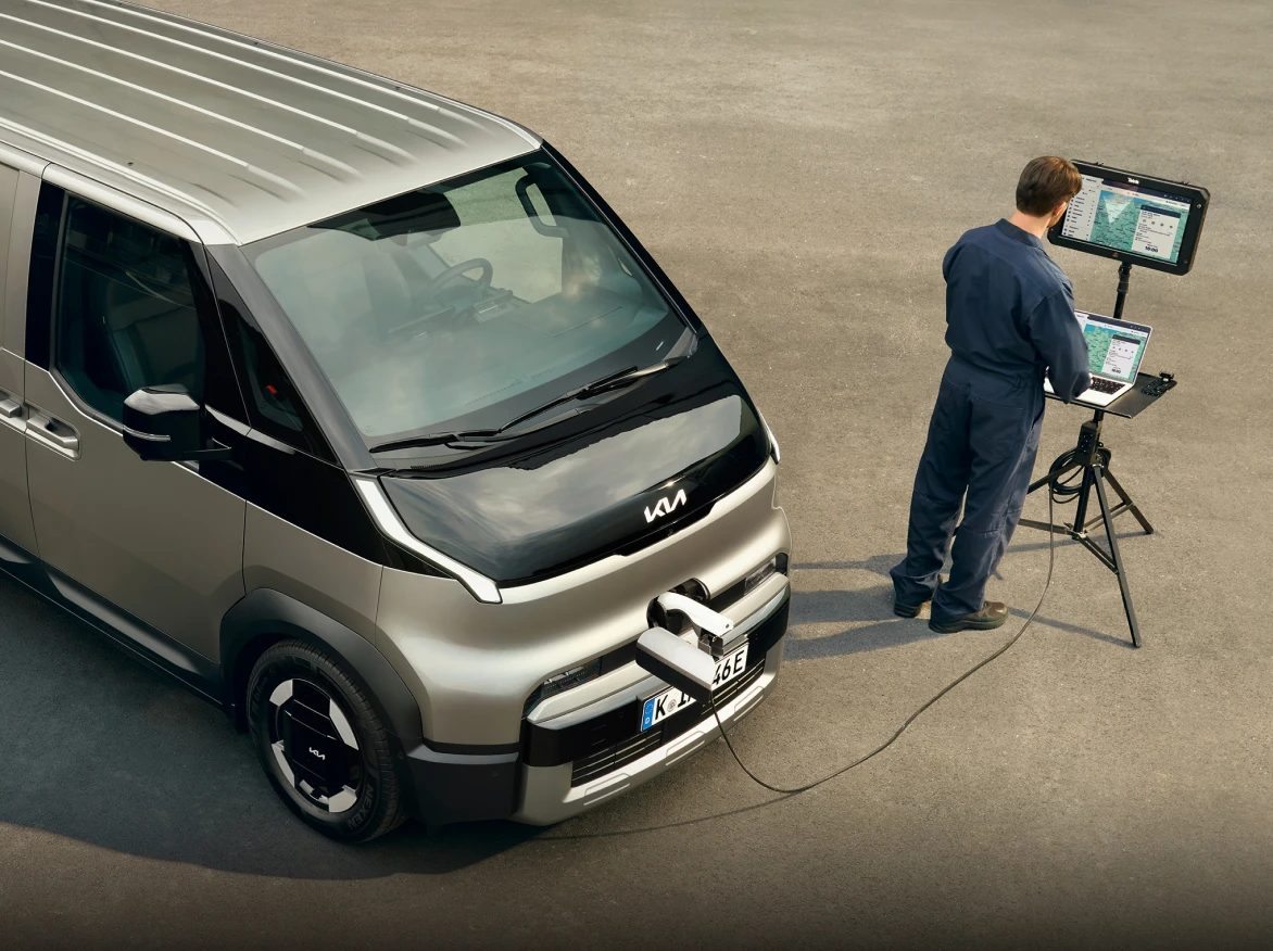 Image of using work equipment beside the Kia PV5 vehicle