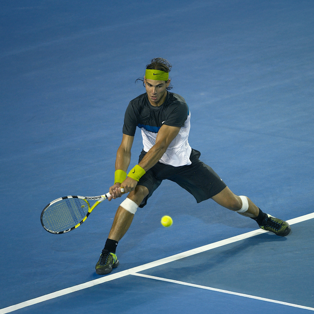 Rafael Nadal returning a shot on the court