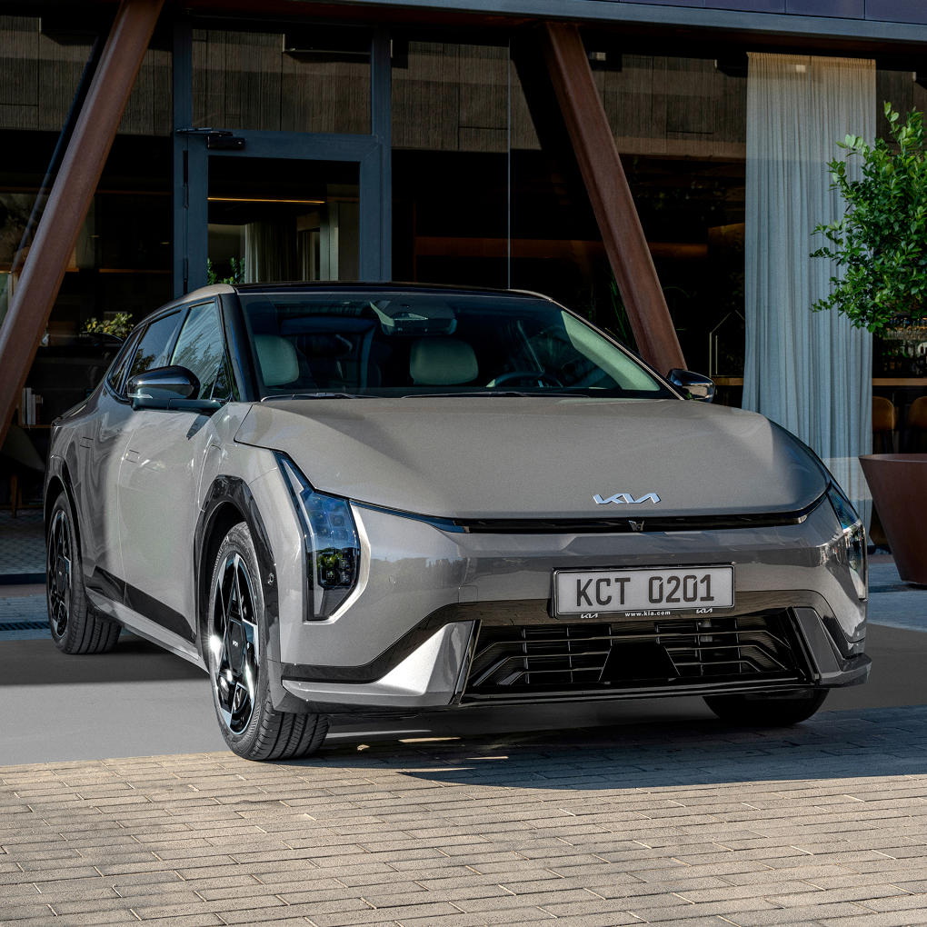 Front view of a Kia sedan parked in front of a building