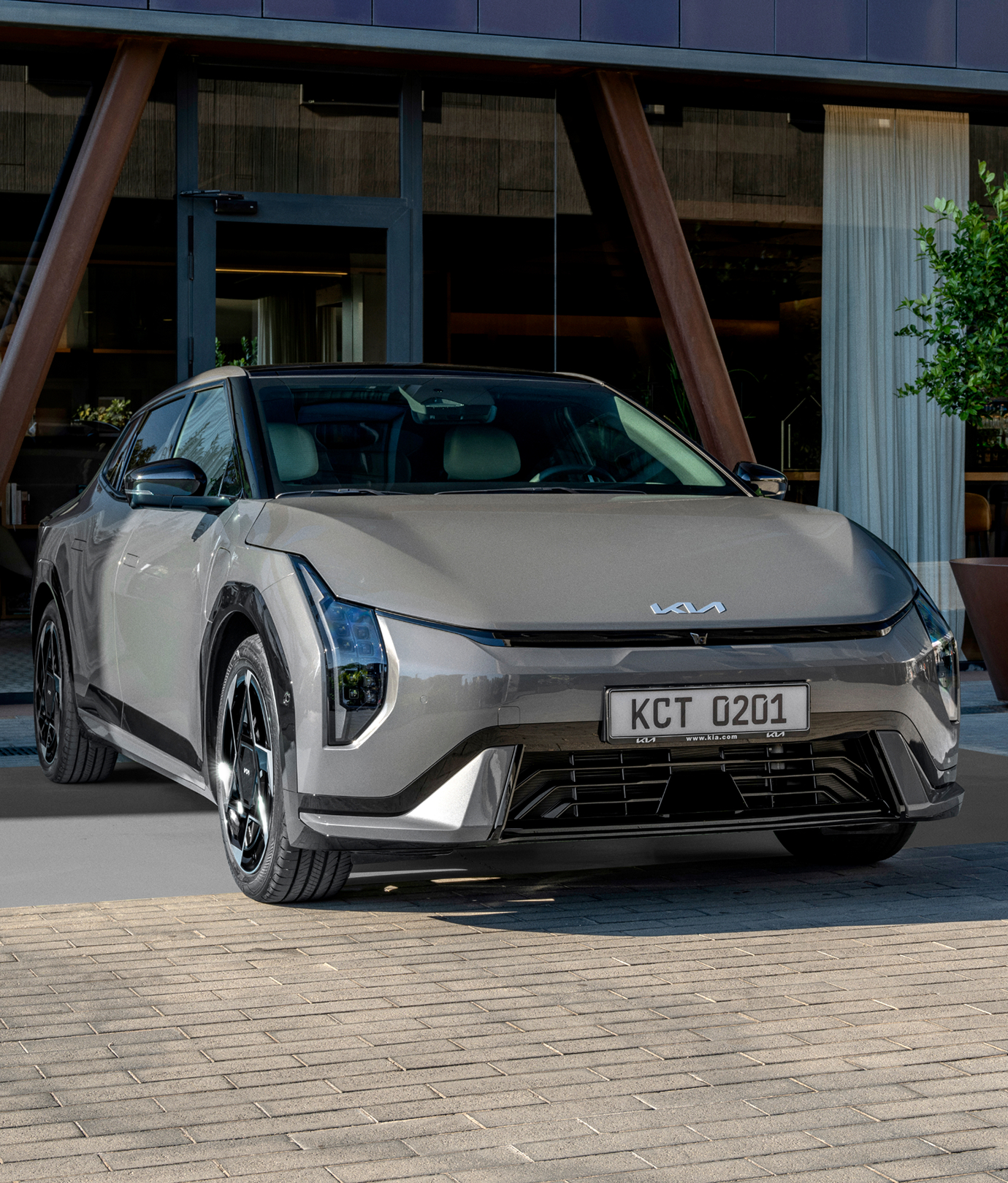 Front view of a Kia sedan parked in front of a building
