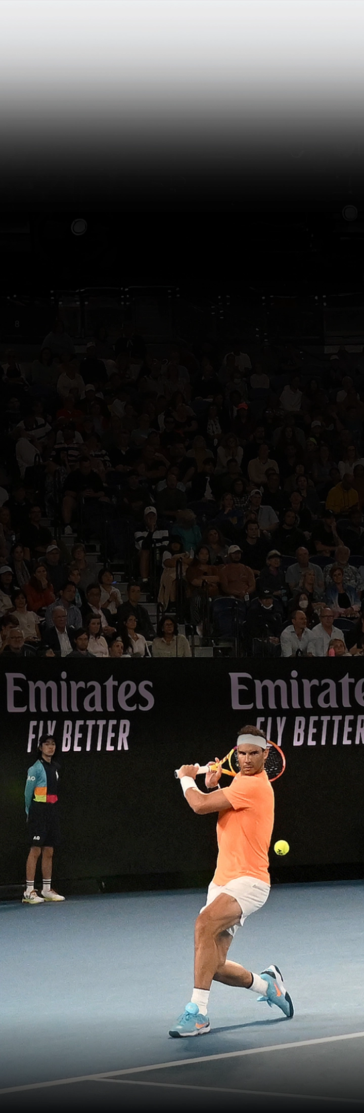 Rafael Nadal hitting a forehand on a court featuring Kia branding