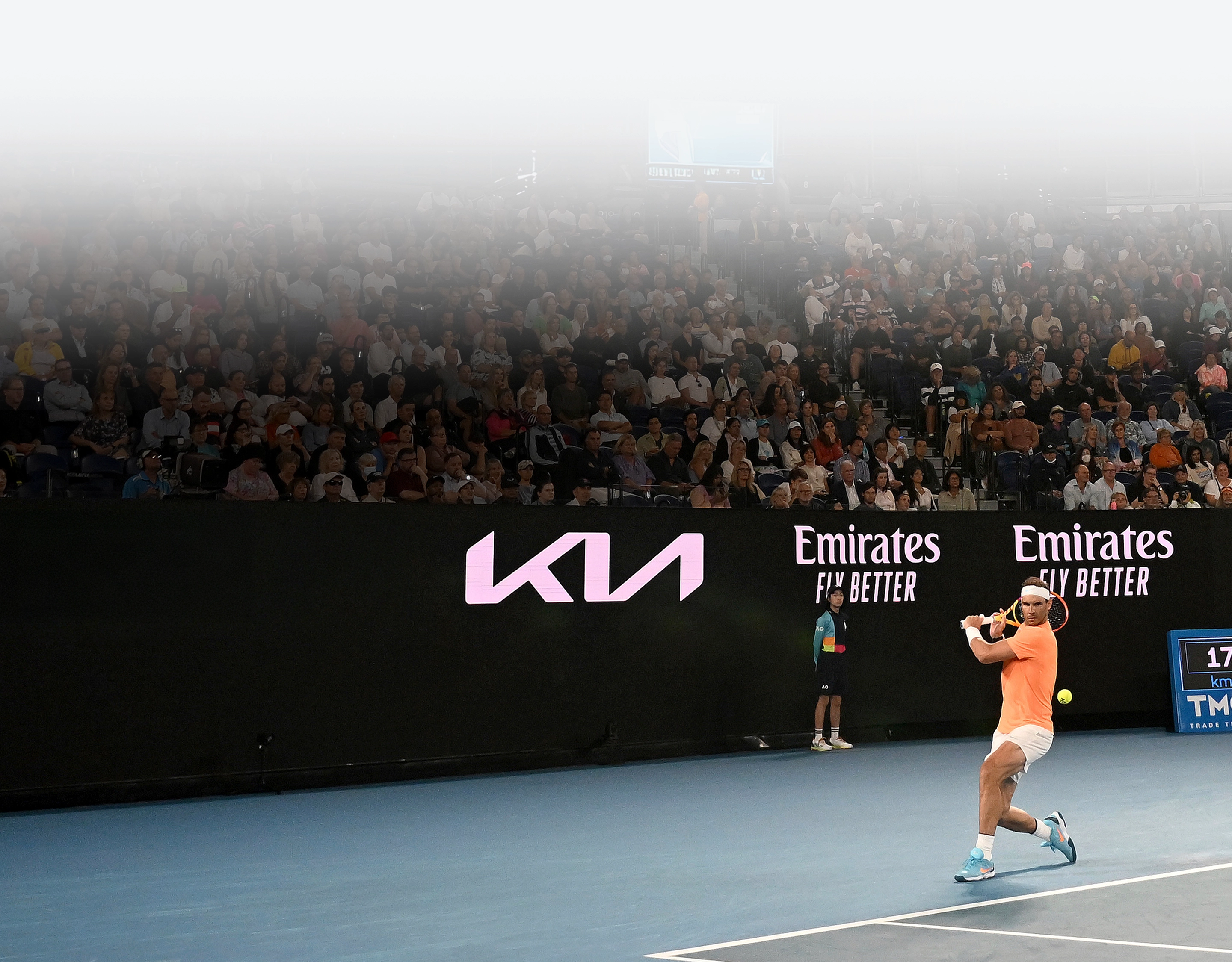 Rafael Nadal hitting a forehand on a court featuring Kia branding