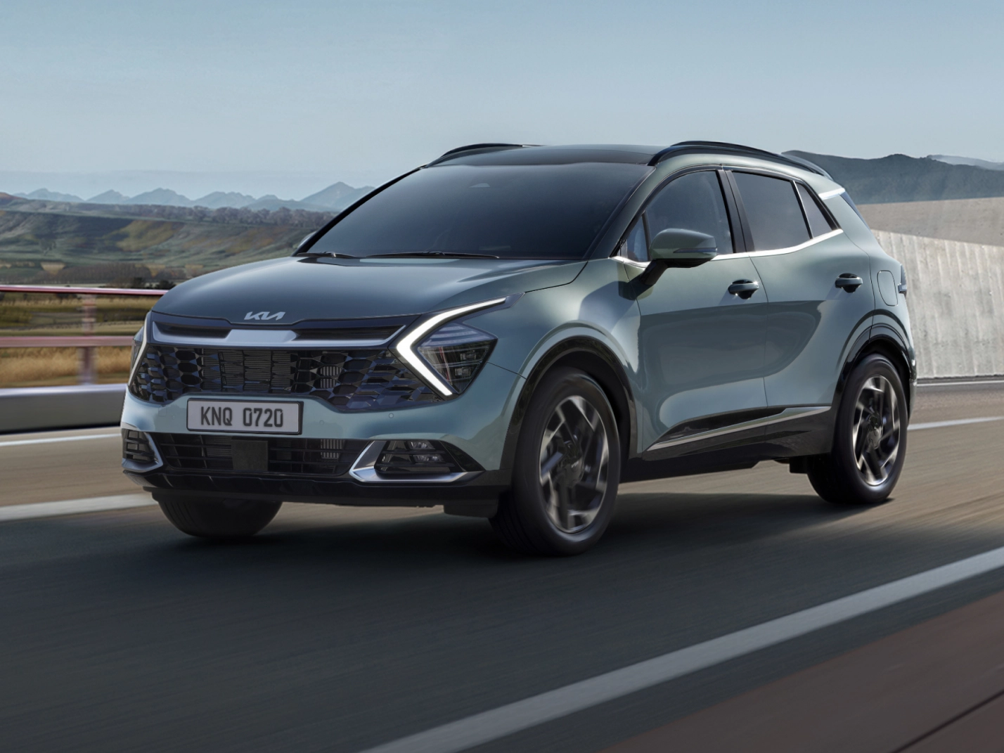 The fifth-generation Kia Sportage driving on a highway